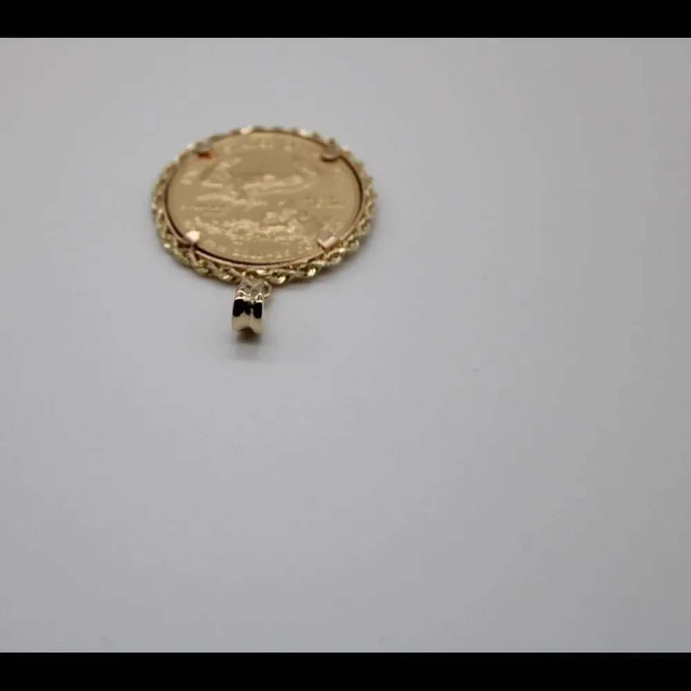 New 22k gold American Eagle 1/2 ounce coin mounted in 14k gold coin bezel